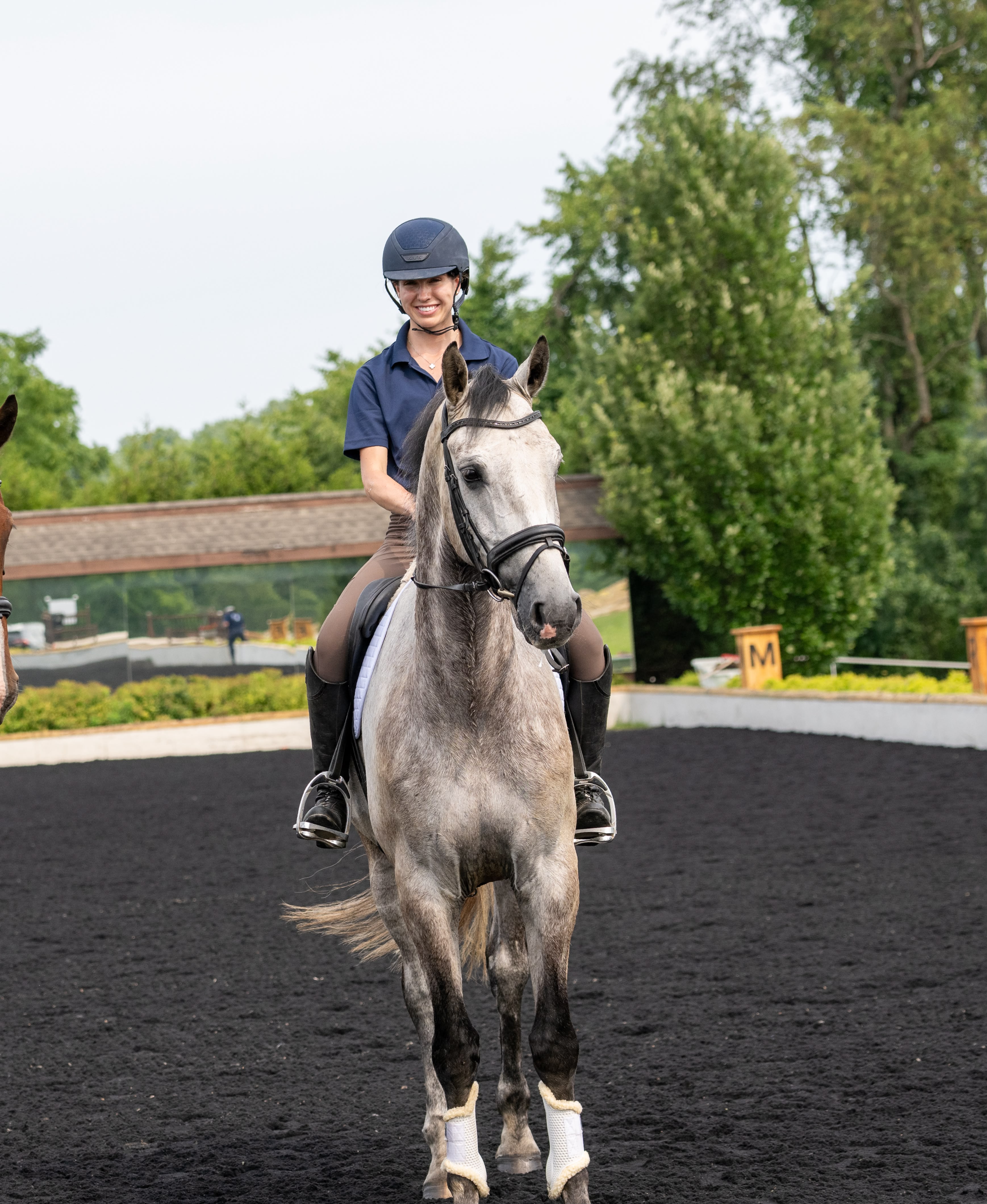 Martha Tomlinson riding a dapple grey sport horse